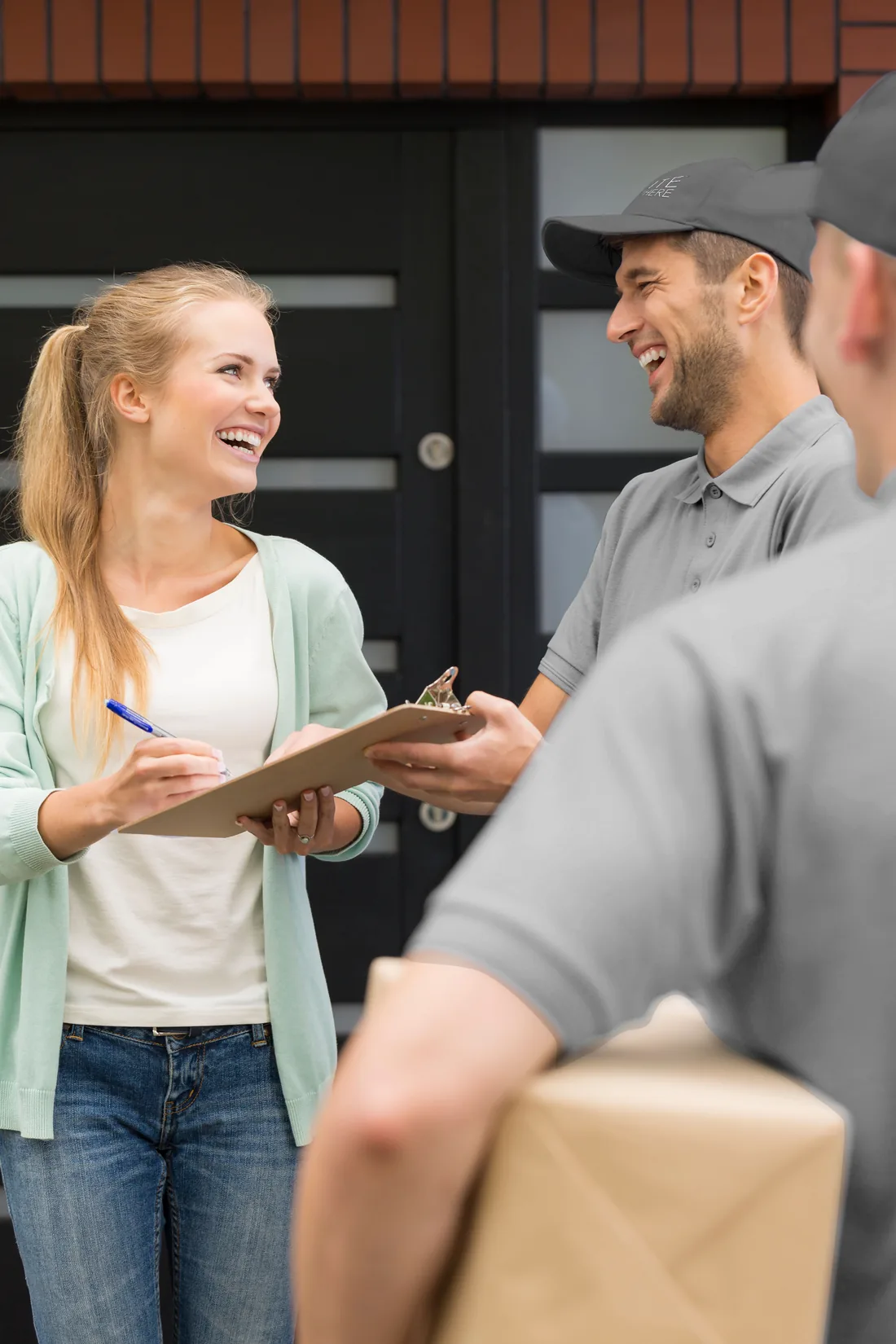 Elite Anywhere delivery — customer signing at the doorstep of a Nashville home