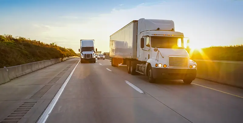 Semi truck on the highway at sunset
