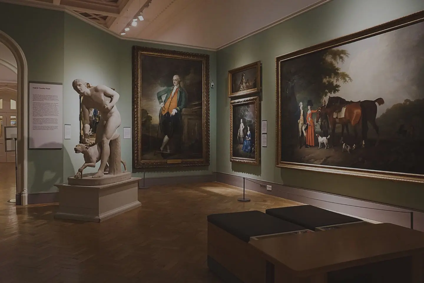 Art gallery with paintings and a statue